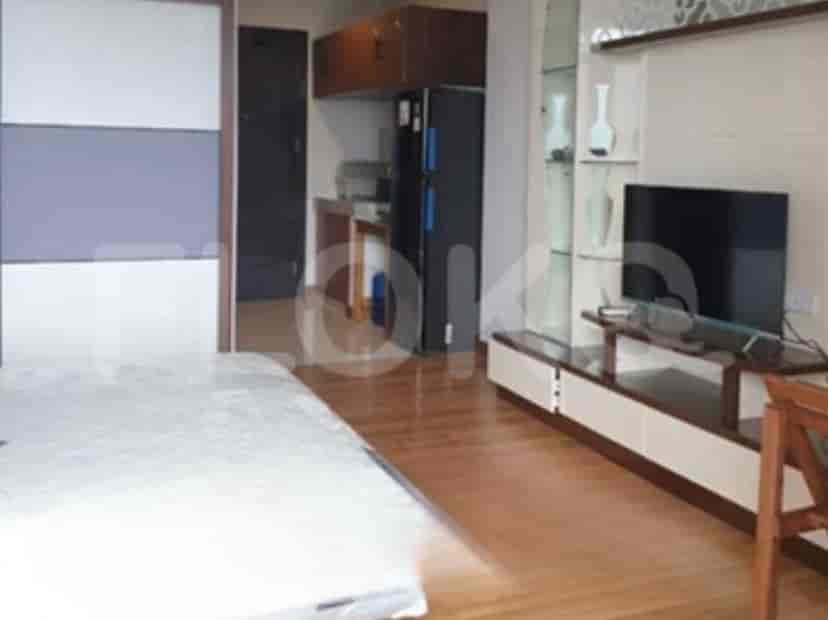 Living space with kitchen and entertainment area.