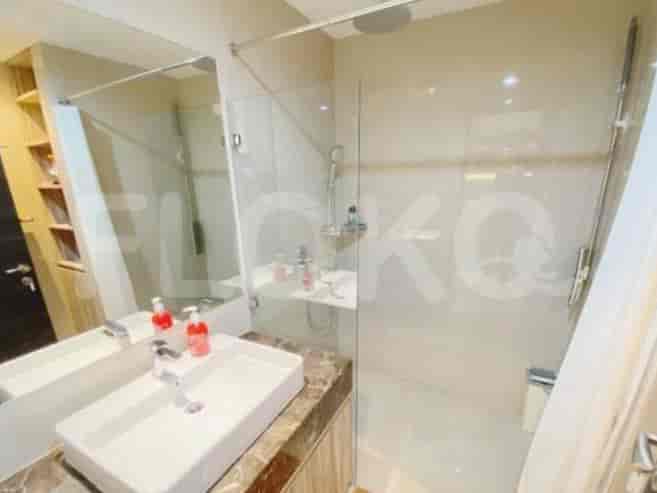 Modern bathroom with a glass shower, vanity, and sink.