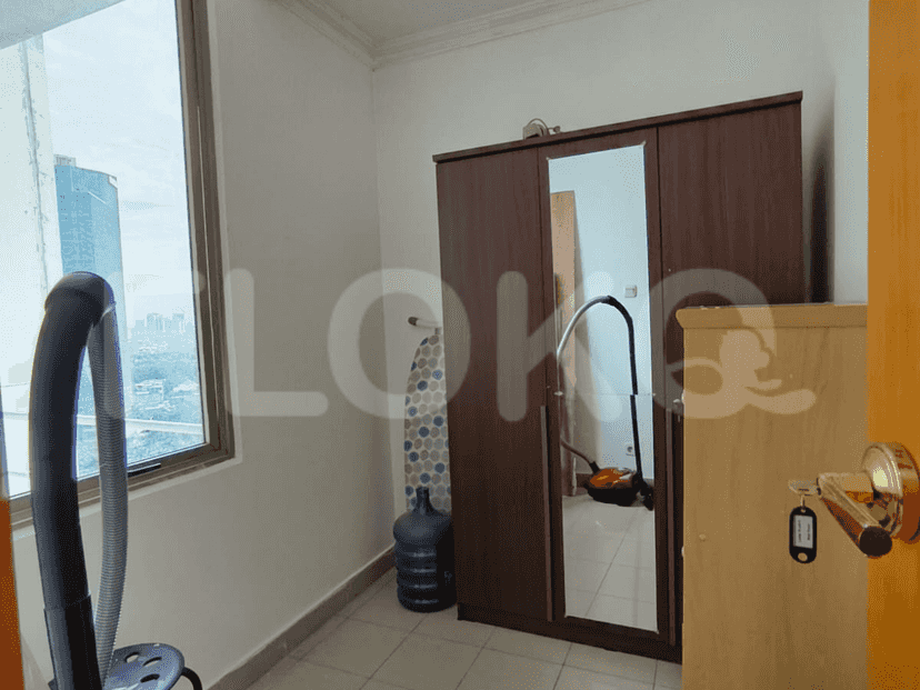 Utility room with a wardrobe, washing machine, and water dispenser.