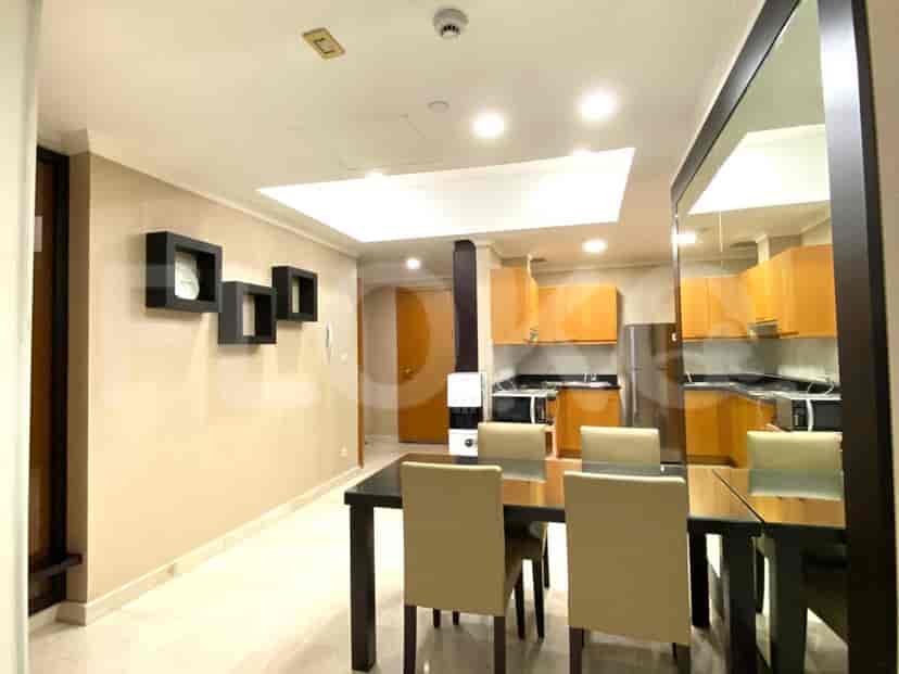 Dining area with a table and chairs and a view into the kitchen.