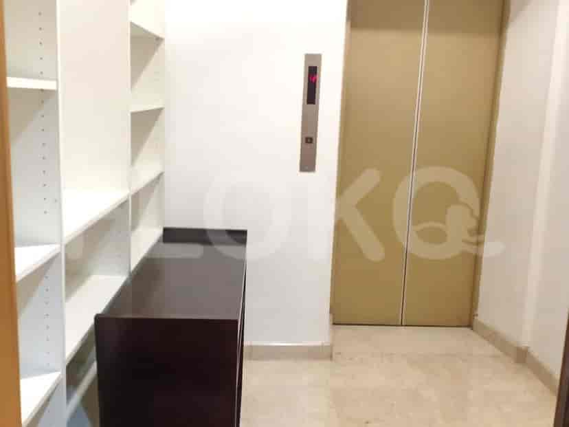 Hallway with shelves and an elevator.