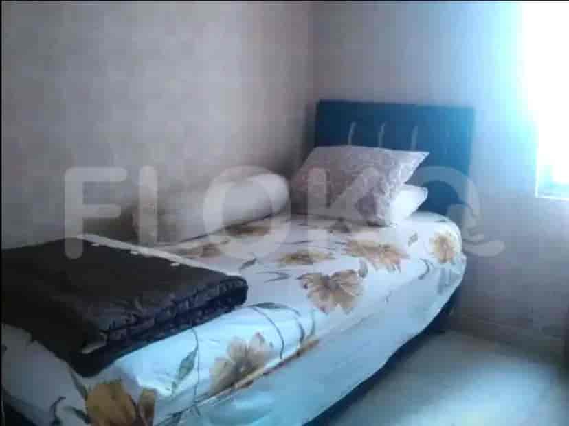 Bedroom with a floral bedspread.