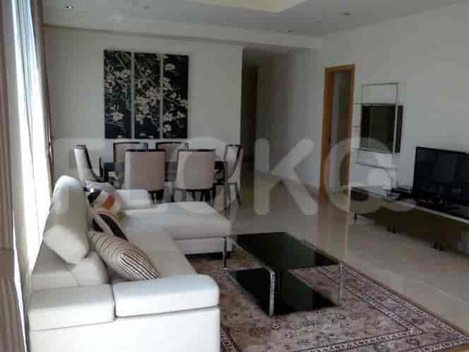 A modern living and dining area with a sectional sofa, dining table, and artwork.