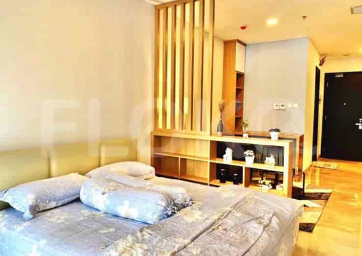 Bedroom with bed, decor, and divider unit.