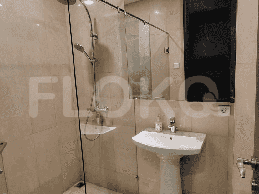 A bathroom with a sink, shower, and mirror.
