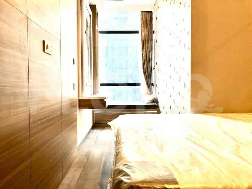 Bedroom with wooden closet and window.