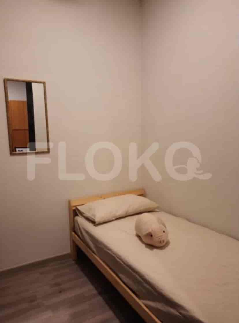 A small bedroom with a single bed and a plush toy on it.