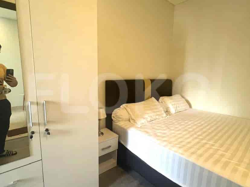 A bedroom with a double bed and a wardrobe.