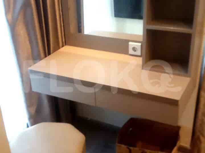 A vanity with a mirror, drawers, and a stool.
