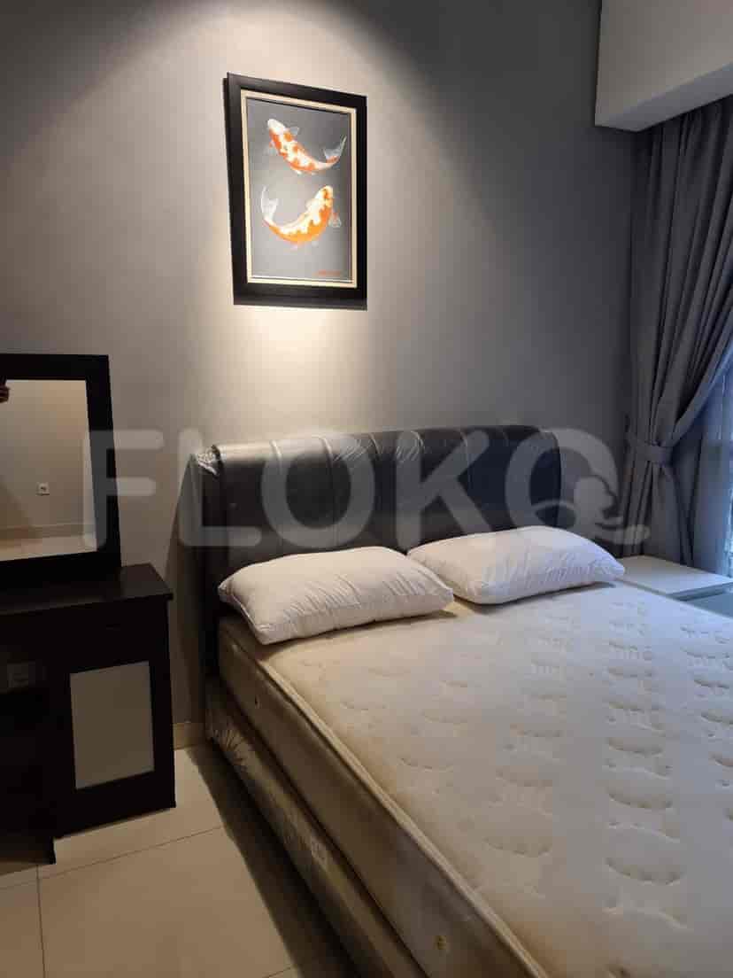 Bedroom with a bed, artwork, and curtains.