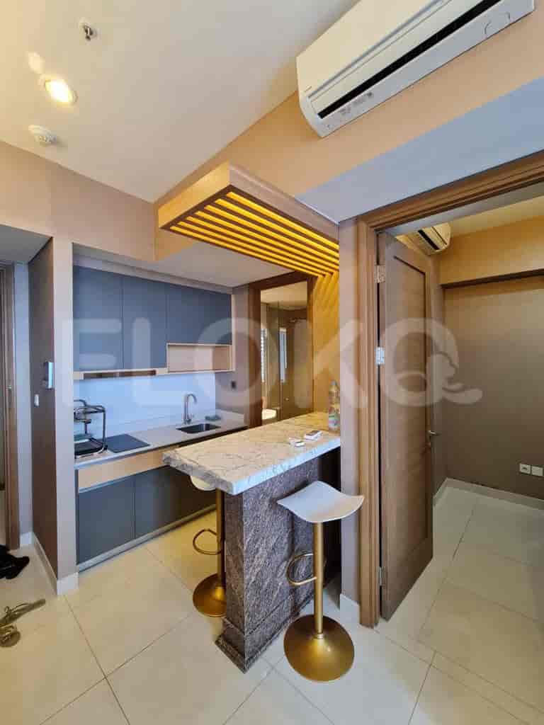 Kitchen and dining space with a bar counter, stools, and a view into another room.