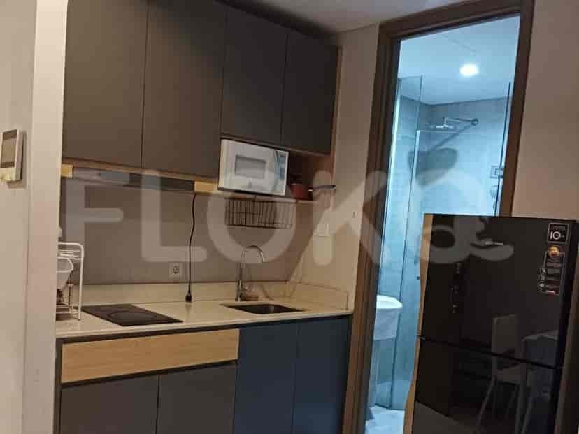 A modern kitchen with cabinets, an electric stove and microwave.