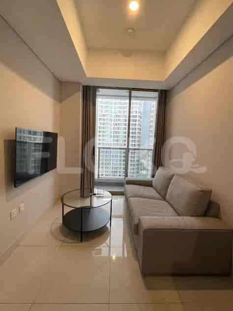 Living room with a sofa and television.