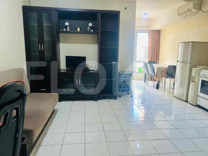 Living room with a TV cabinet, sofa, and dining area visible.