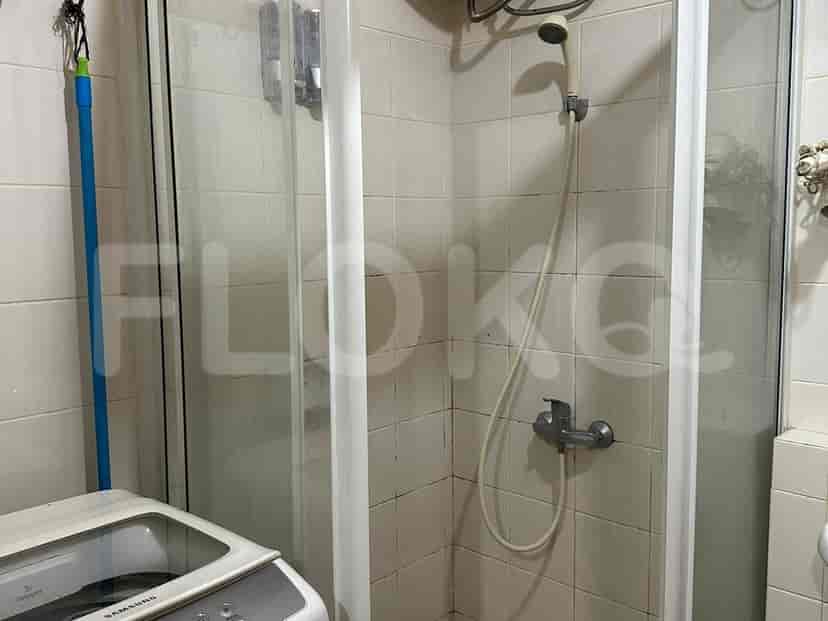 Bathroom with shower and washing machine.