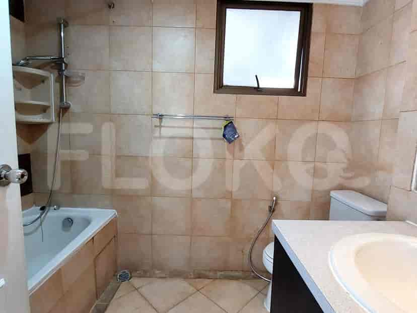 Bathroom with a bathtub, a window, and tiled walls.