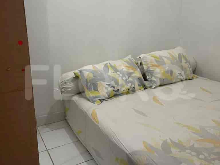 A smaller bedroom with a bed