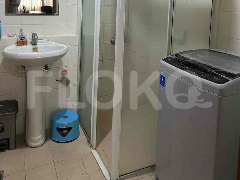 Kamar mandi dengan wastafel, shower, dan mesin cuci.