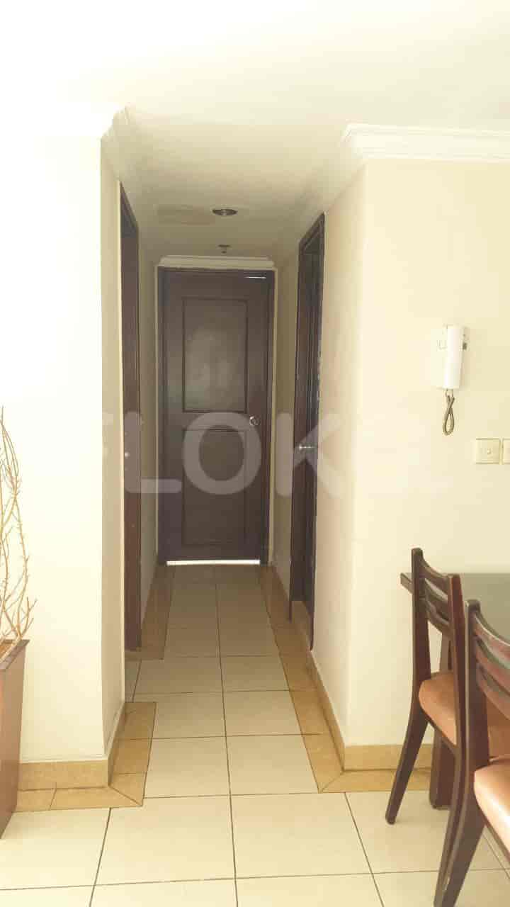 Hallway with doors, tile flooring, and a wall-mounted intercom.