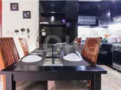 A dining area with a table and chairs adjacent to the kitchen.