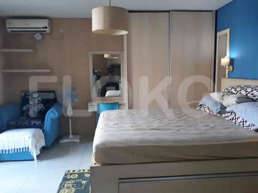 Bedroom with a bed, a small sofa, and a vanity.