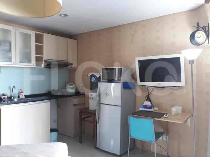 Compact kitchen with basic appliances.