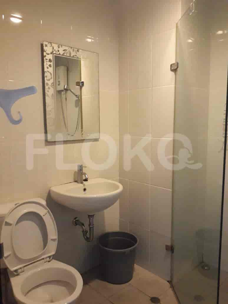 Bathroom with a toilet, sink, and a shower.