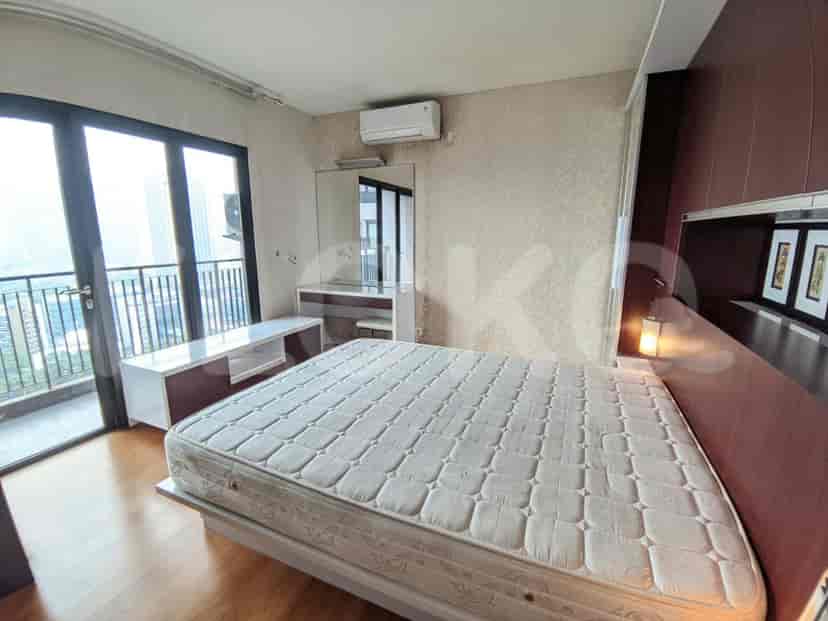 A bedroom with a large bed, a vanity area, and access to a balcony. Features include modern decor and a comfortable atmosphere.