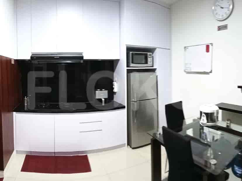 A well-equipped kitchen with modern appliances and a dark backsplash.