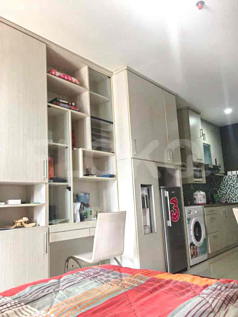 Kitchen and study area with built-in cabinets and a desk.