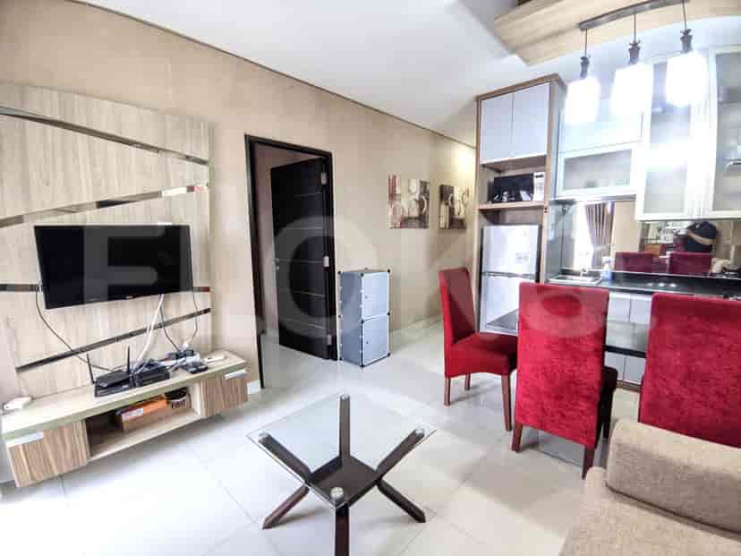 A wider shot of the living and dining area, showing a dining area.