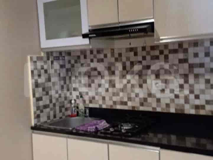 Kitchen with a sink, cabinets, and a stove.