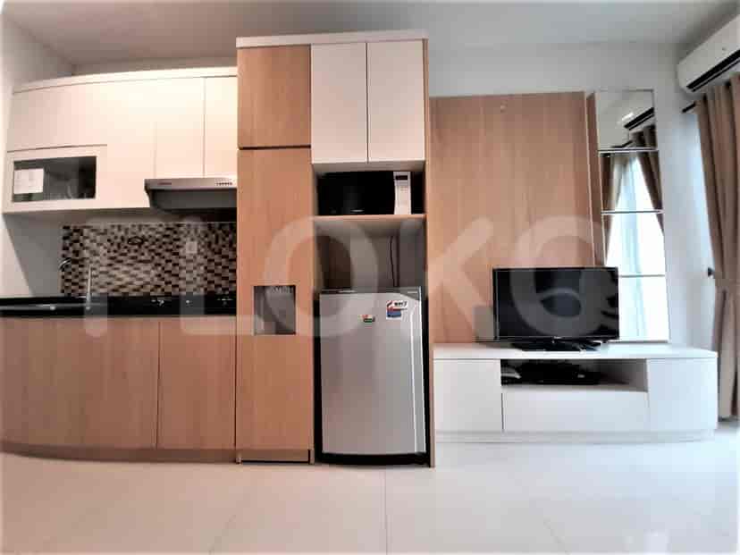 An integrated kitchenette with modern appliances and cabinets.