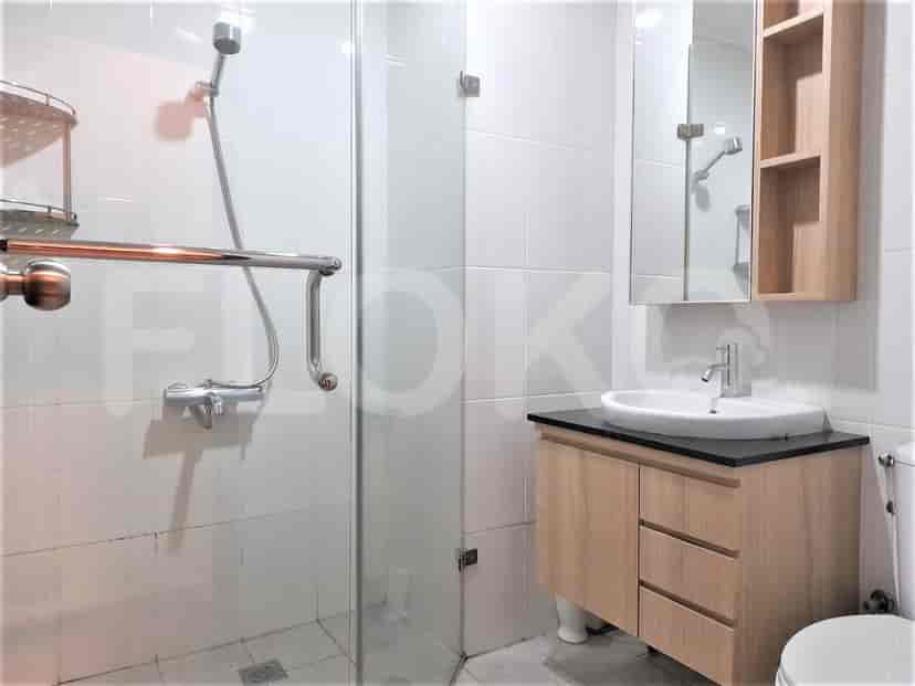 A contemporary bathroom with a walk-in shower, vanity, and toilet.