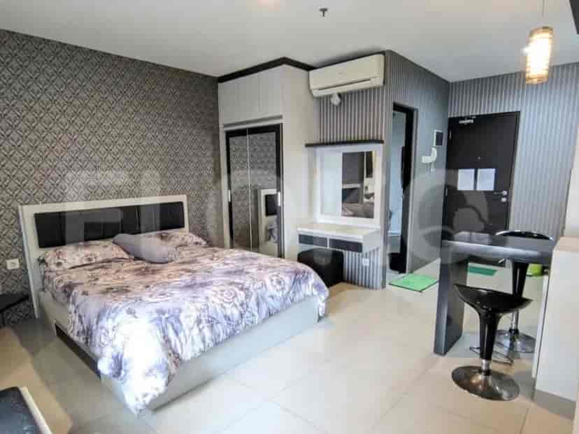 A bedroom with a bed, closet, and bathroom entry.