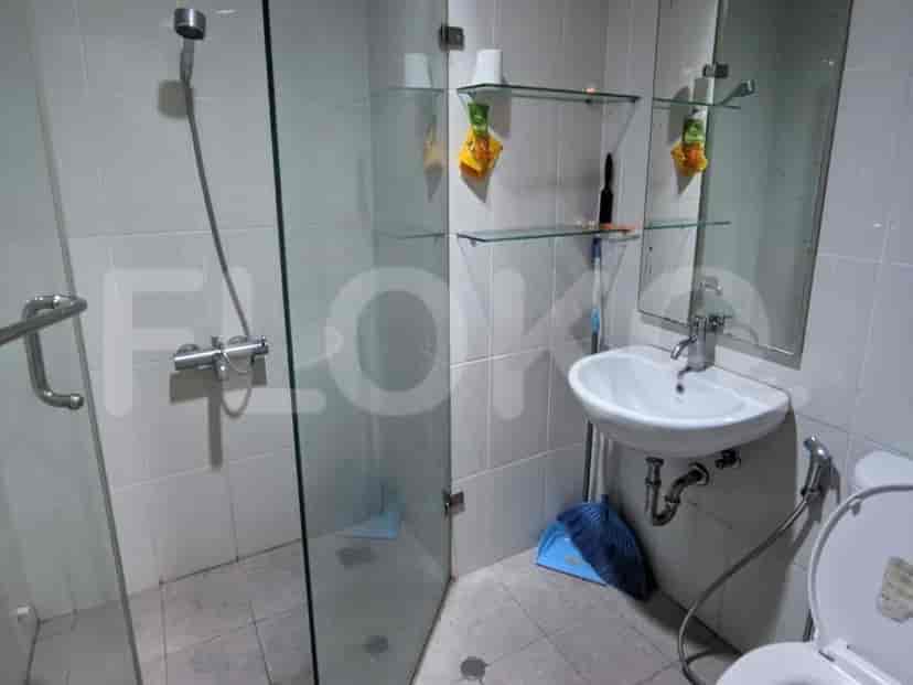 A modern bathroom with a glass-enclosed shower.