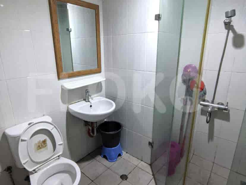 A bathroom with a toilet, sink, and shower.