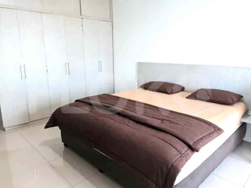 A bedroom with a double bed, closet, and a view.