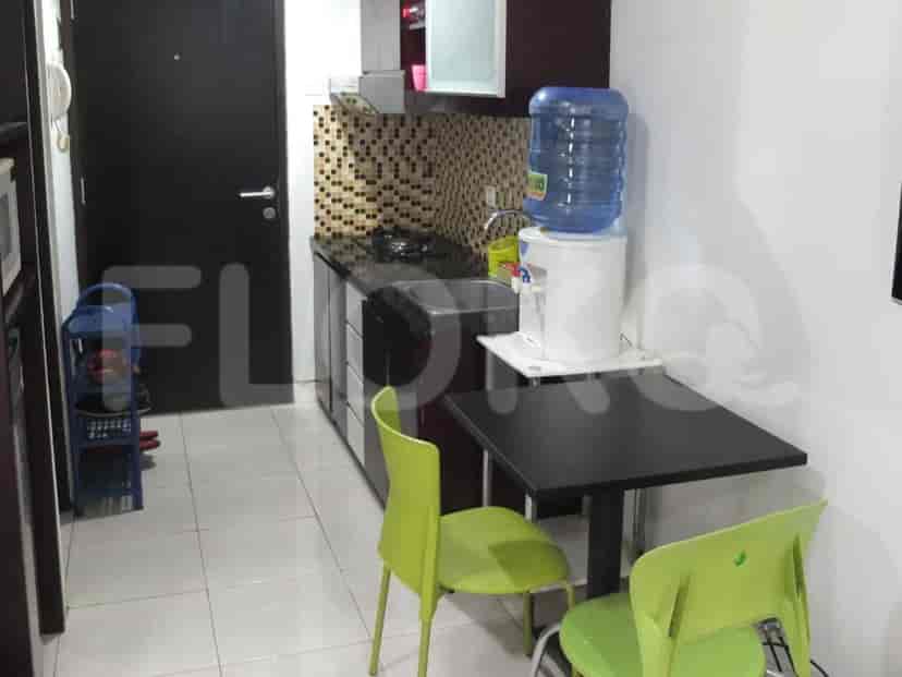 Small kitchen with counter space, sink and dining area.