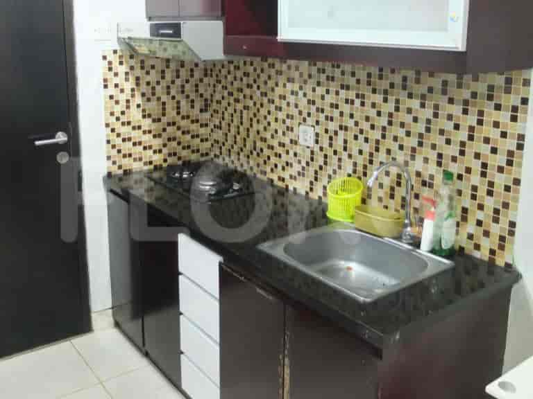 Close-up of kitchen counters, stove, and sink.