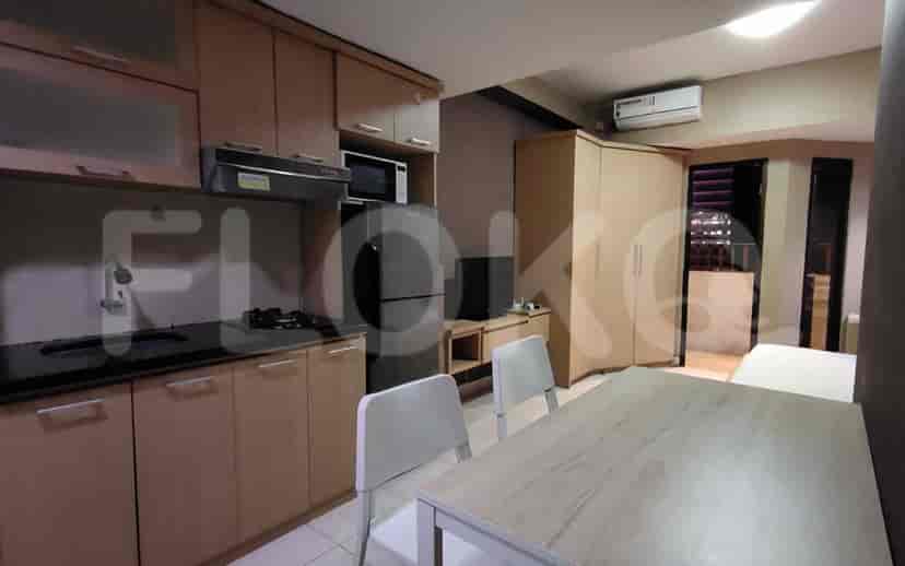 A view of the kitchen and dining space, including appliances, dining table, and air conditioning.