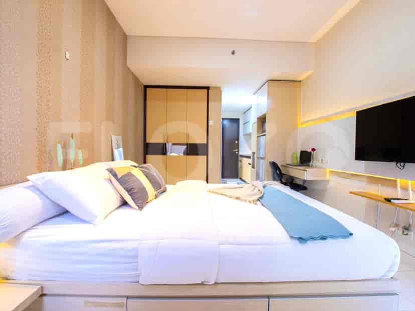 A modern bedroom with large bed, closet, and TV.