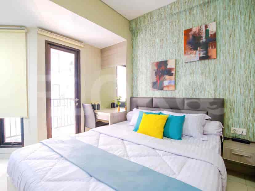 Bedroom with a double bed, desk and artwork.