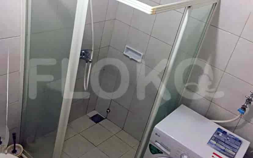 Bathroom with a shower and a washing machine.