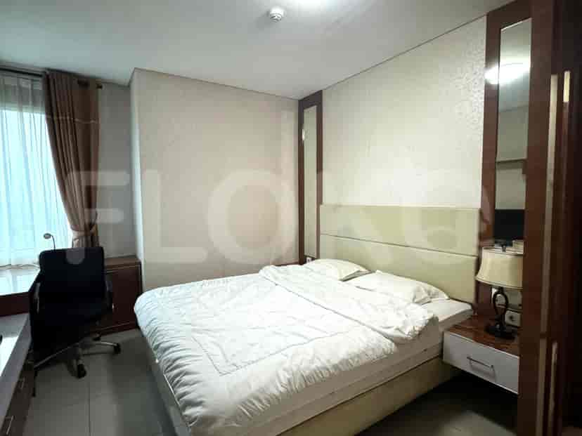Bedroom with a double bed, large mirror, and work desk by the window.