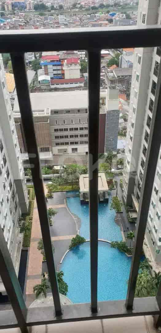View from a balcony overlooking a swimming pool.