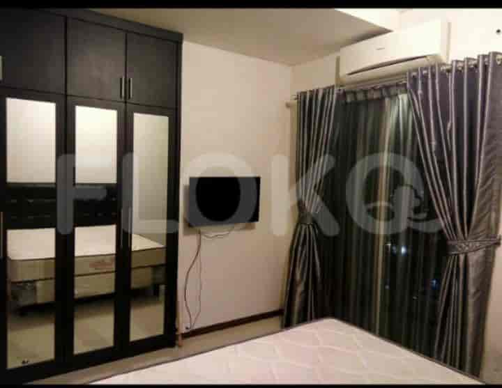 Bedroom with a wardrobe, a smart TV, and a view.