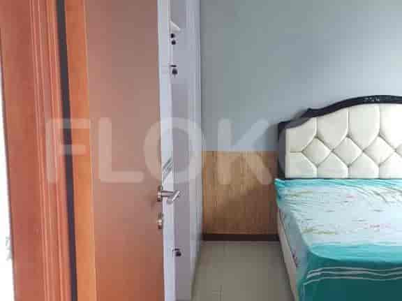 A bedroom featuring a bed, wardrobe, and a door.