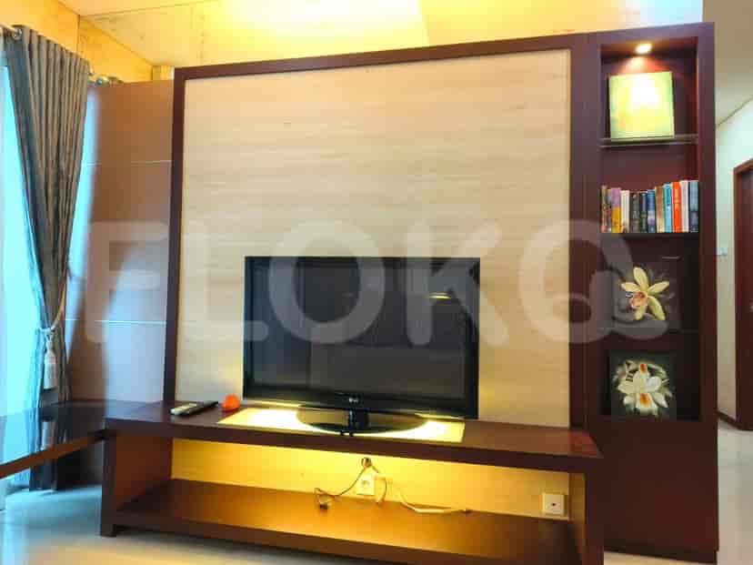 Living room with TV and wall decor.