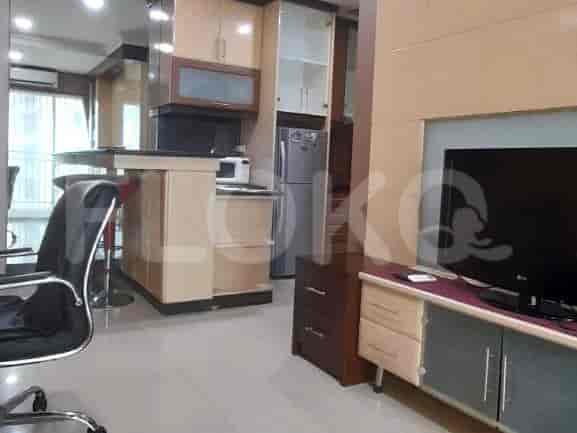 A well-equipped kitchen with a breakfast bar, cabinets, and a refrigerator.
